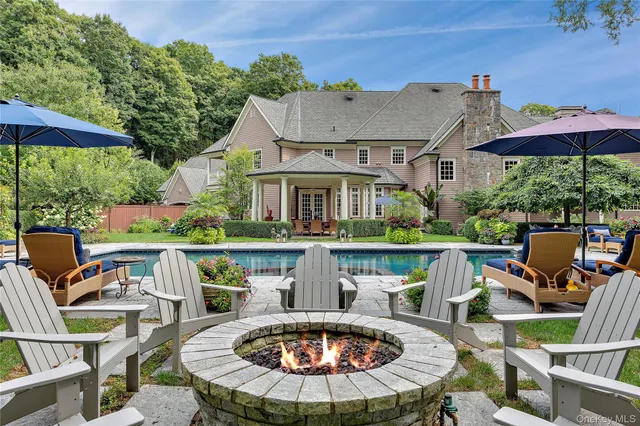 a view of house with swimming pool outdoor seating area