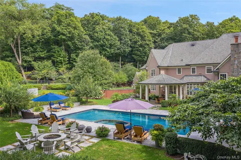 an aerial view of a house swimming pool patio and outdoor seating