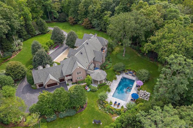 an aerial view of a house with outdoor space pool seating area and yard
