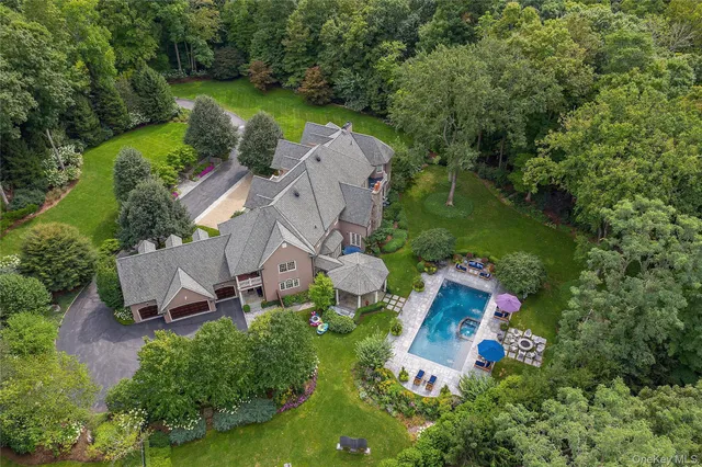 an aerial view of a house with outdoor space pool seating area and yard