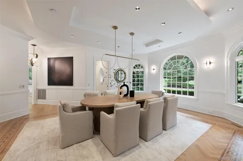 a very nice looking dining room with furniture window and wooden floor