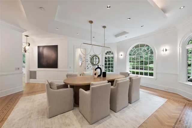 a very nice looking dining room with furniture window and wooden floor