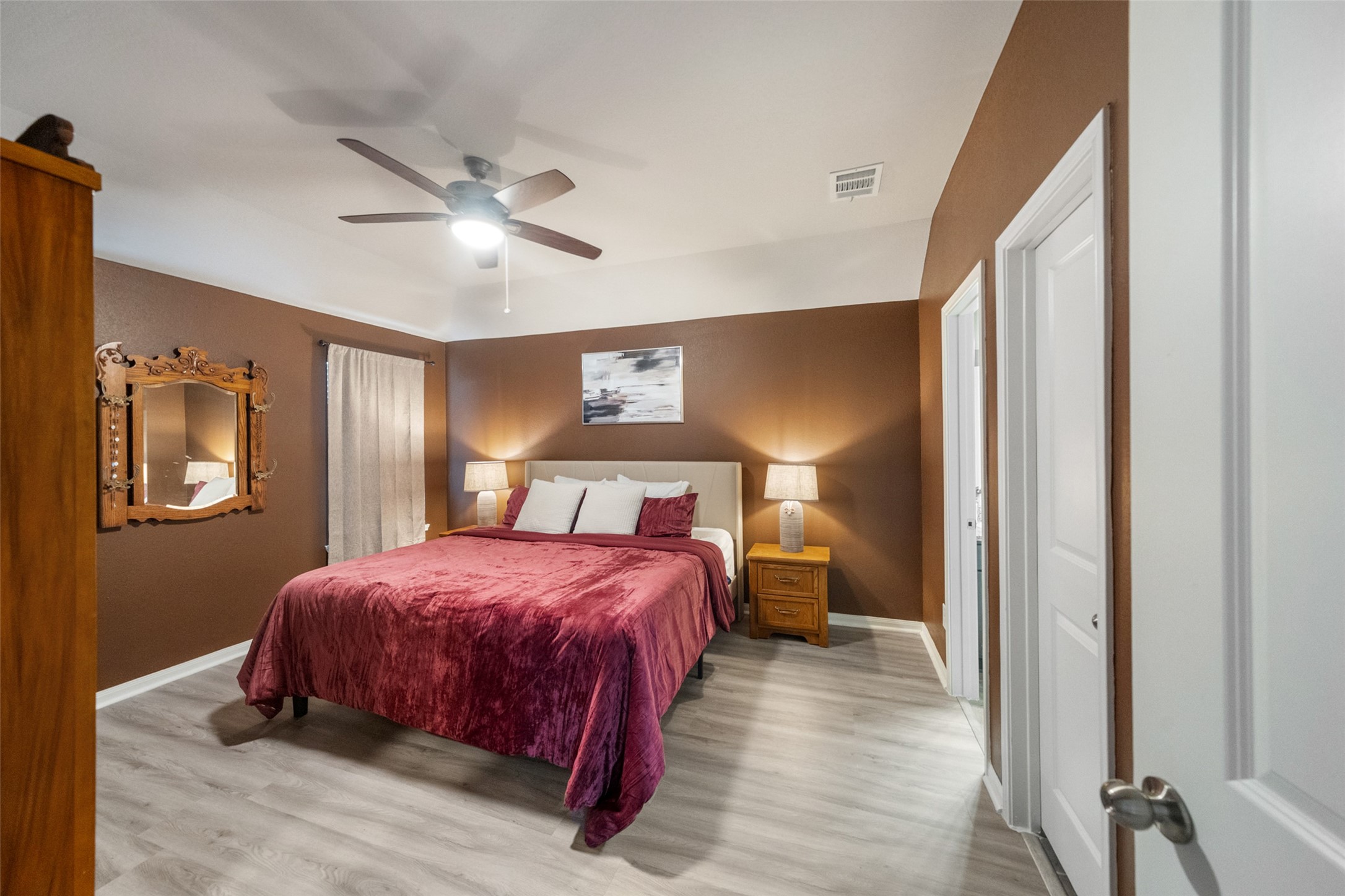 26431 Pin Oak Drive Hempstead, TX 77445 - Photo 16 of 32 Primary bedroom with vaulted ceiling, ceiling fan, and a comfortable layout with plenty of room for a full bedroom suite.
