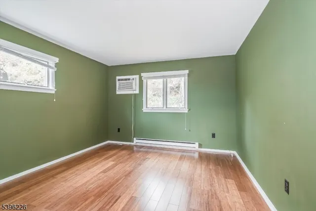 a view of a room with wooden floor and windows