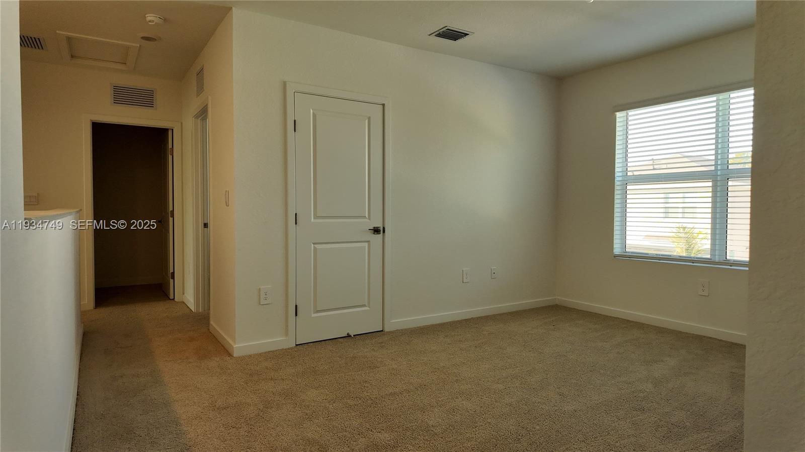 12913 Southwest 265th Terrace, Unit 1 Homestead, FL 33032 - Photo 12 of 22 an empty room that has a window in closet