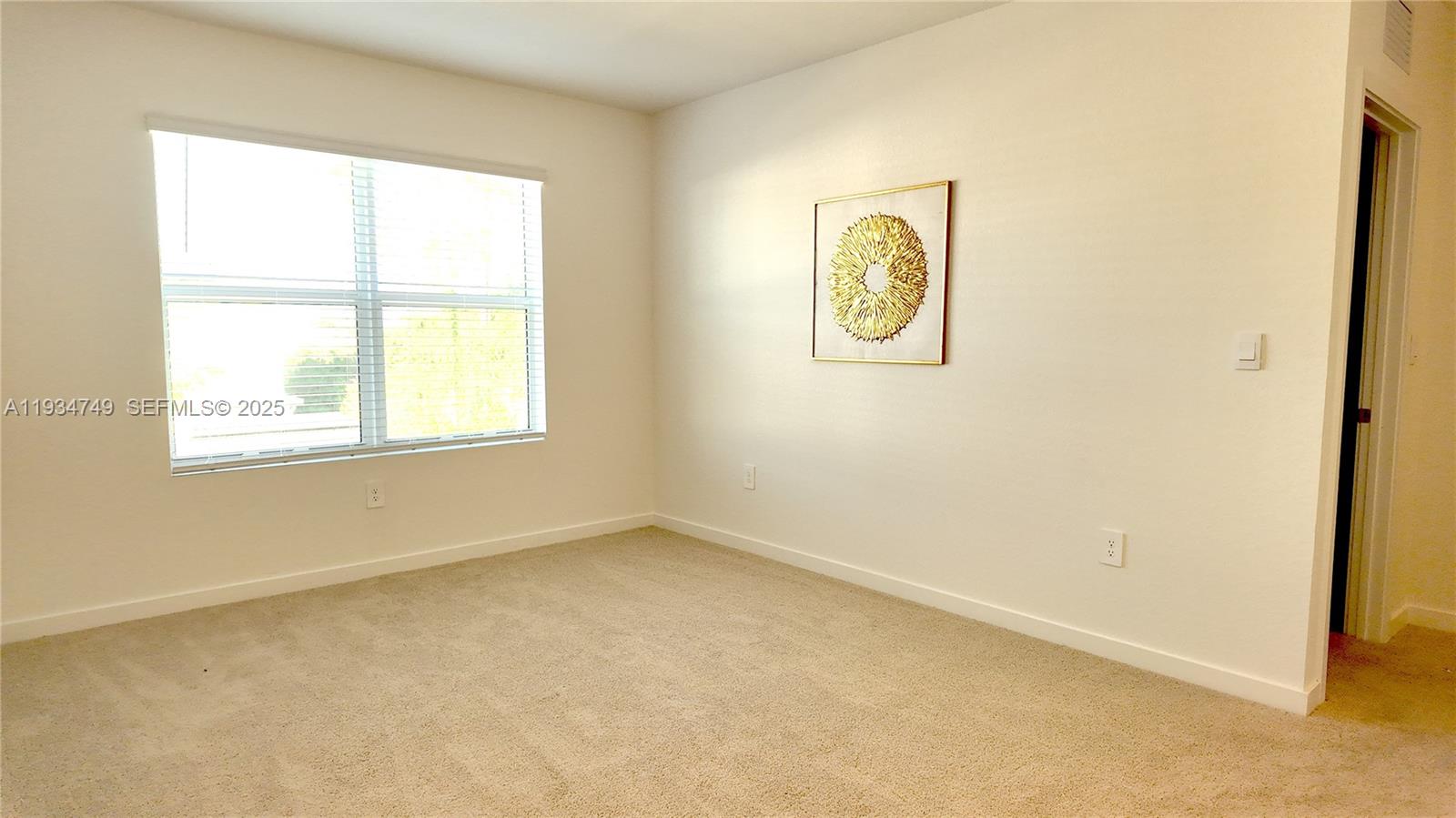 12913 Southwest 265th Terrace, Unit 1 Homestead, FL 33032 - Photo 13 of 22 an empty room with a window