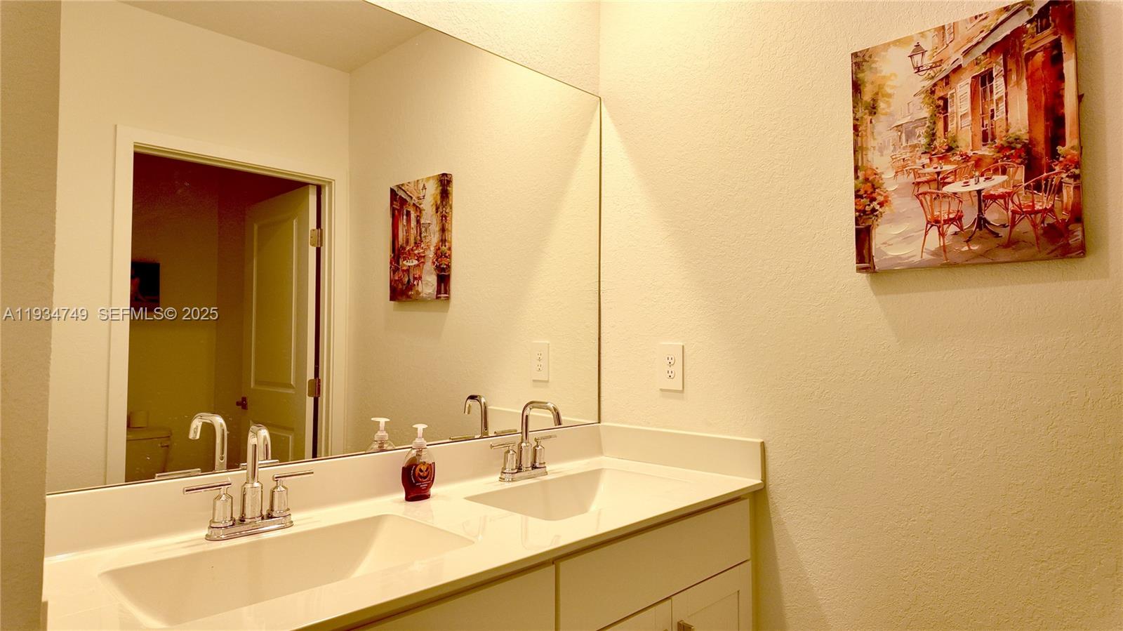 12913 Southwest 265th Terrace, Unit 1 Homestead, FL 33032 - Photo 15 of 22 a bathroom with a sink and a mirror