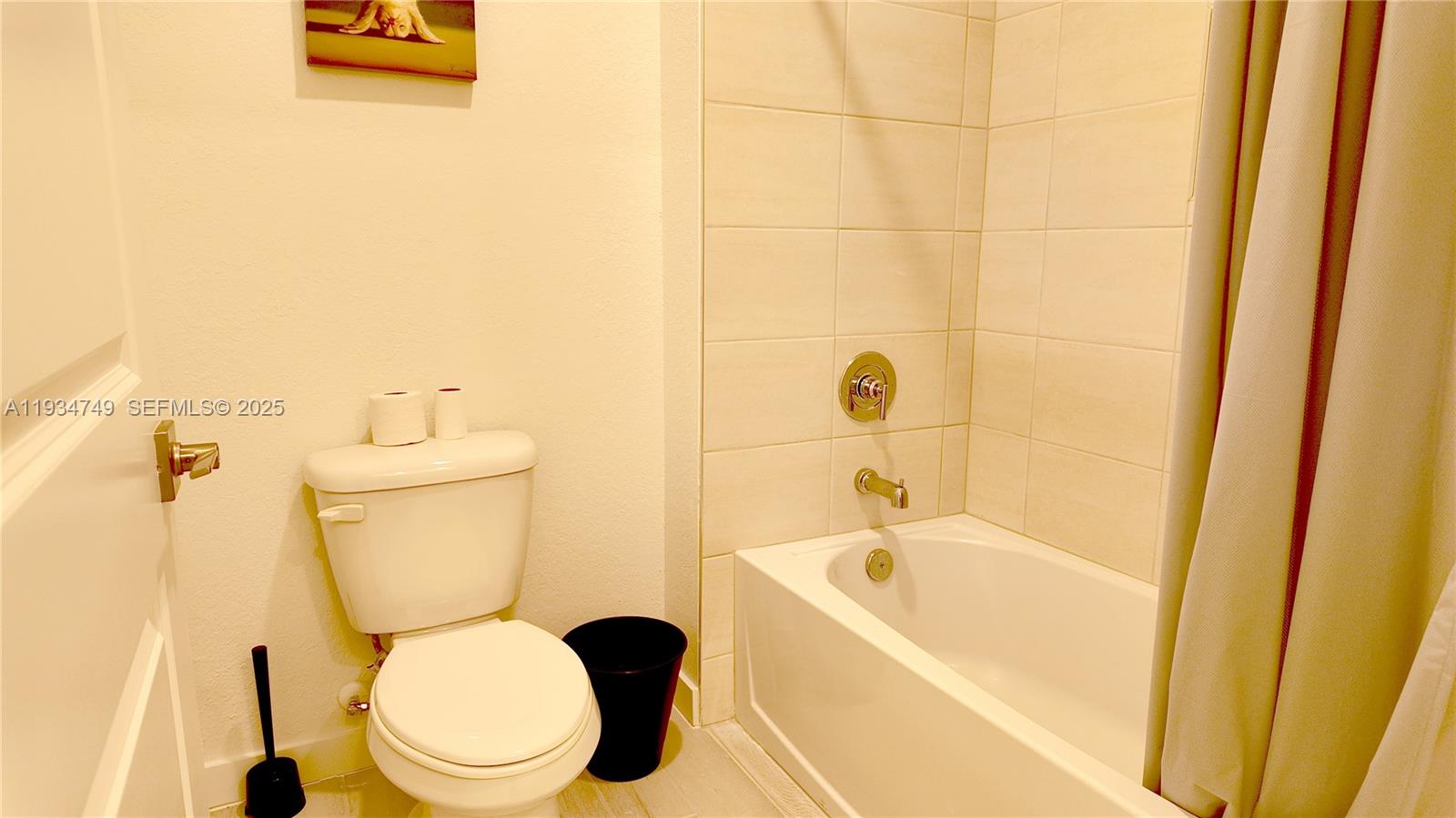 12913 Southwest 265th Terrace, Unit 1 Homestead, FL 33032 - Photo 16 of 22 a white toilet sitting next to a bath tub