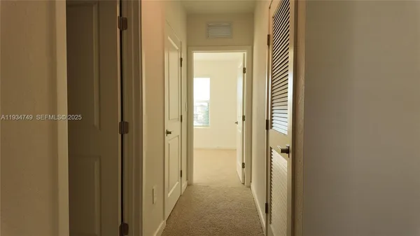 a view of a bathroom from the hallway