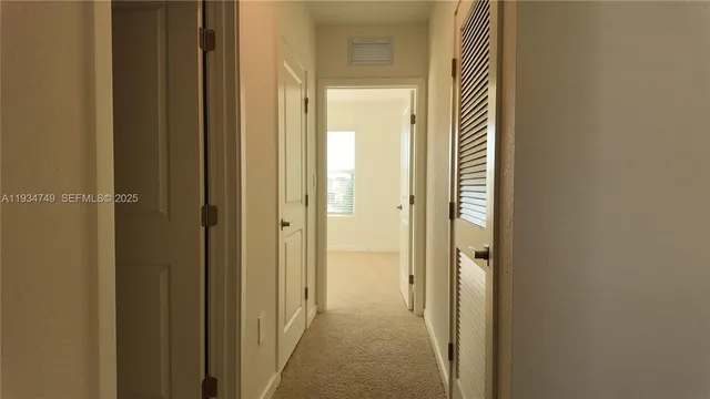 a view of a bathroom from the hallway