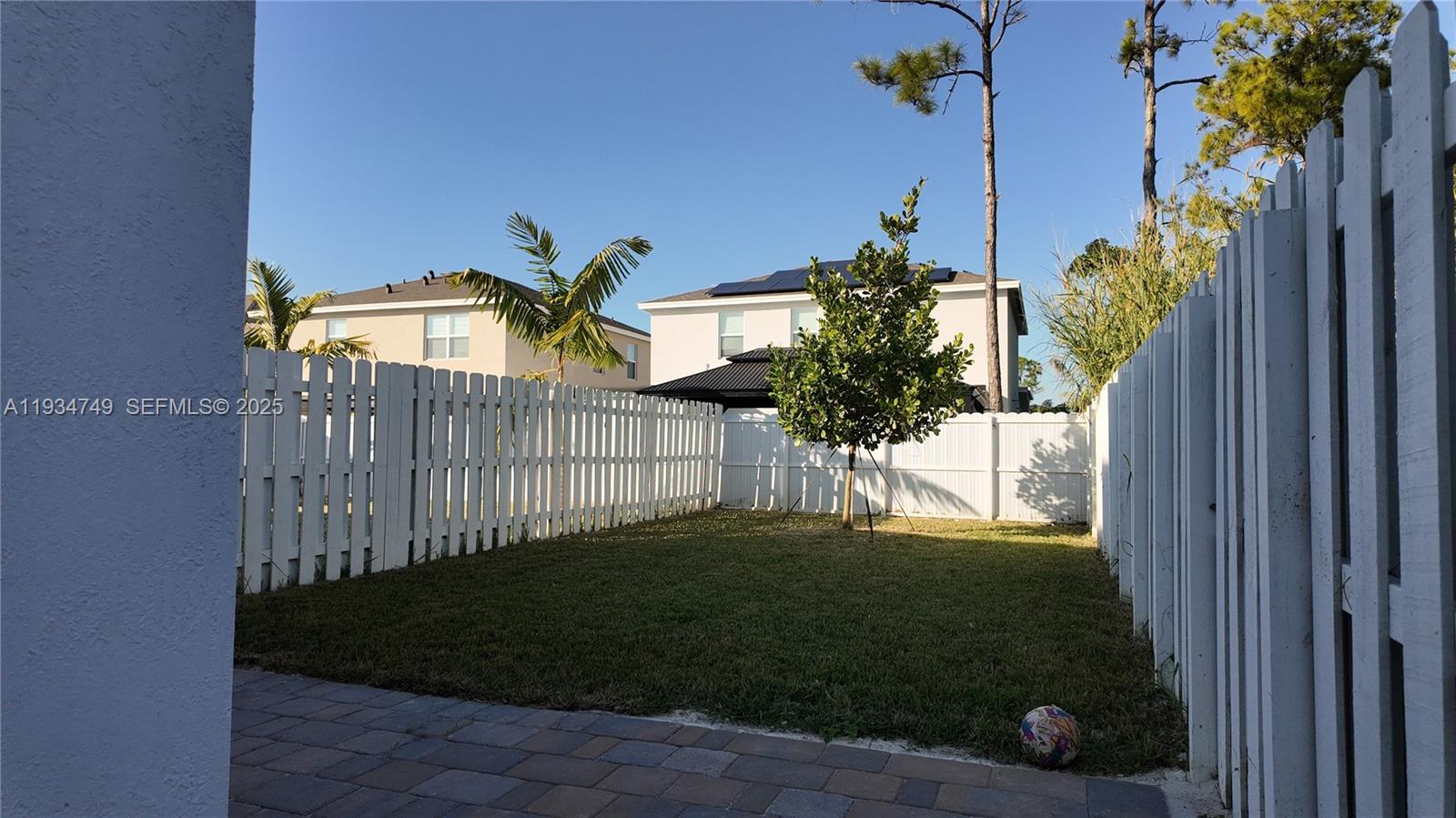 12913 Southwest 265th Terrace, Unit 1 Homestead, FL 33032 - Photo 21 of 22 a view of a house with a small yard