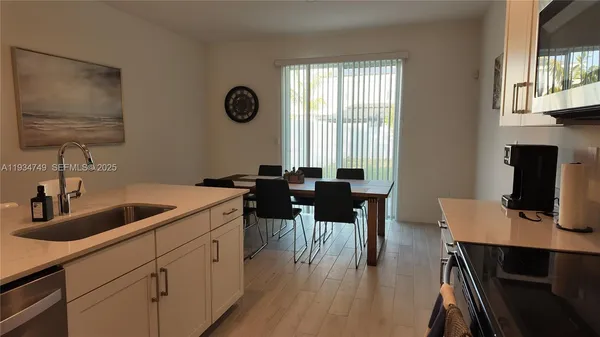a kitchen with a sink cabinets and dining table
