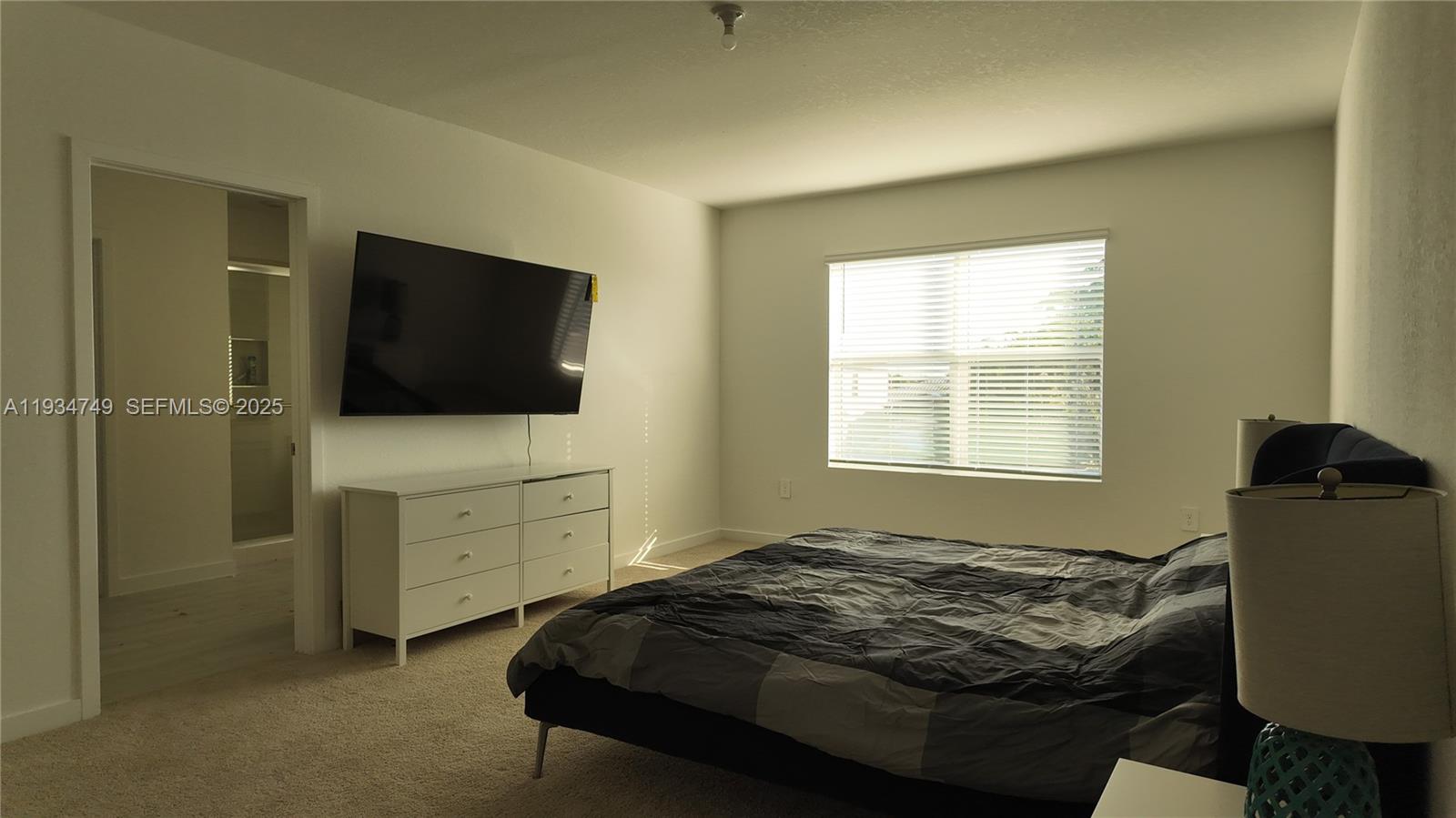 12913 Southwest 265th Terrace, Unit 1 Homestead, FL 33032 - Photo 10 of 22 a bedroom with a bed and furniture