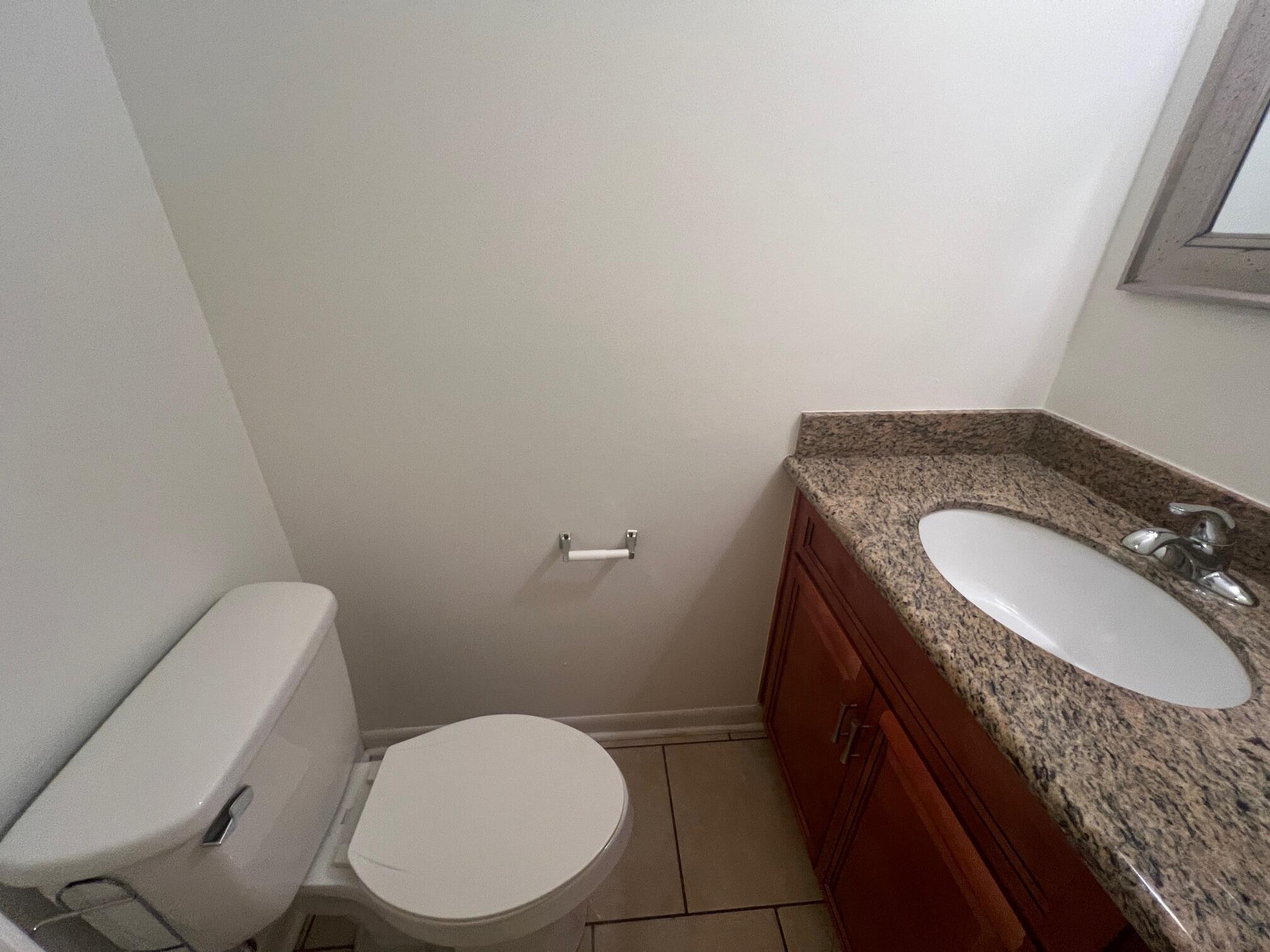115 Hughes Street Northeast, Unit D4 Fort Walton Beach, FL 32548 - Photo 14 of 29 a bathroom with a granite countertop toilet and a sink