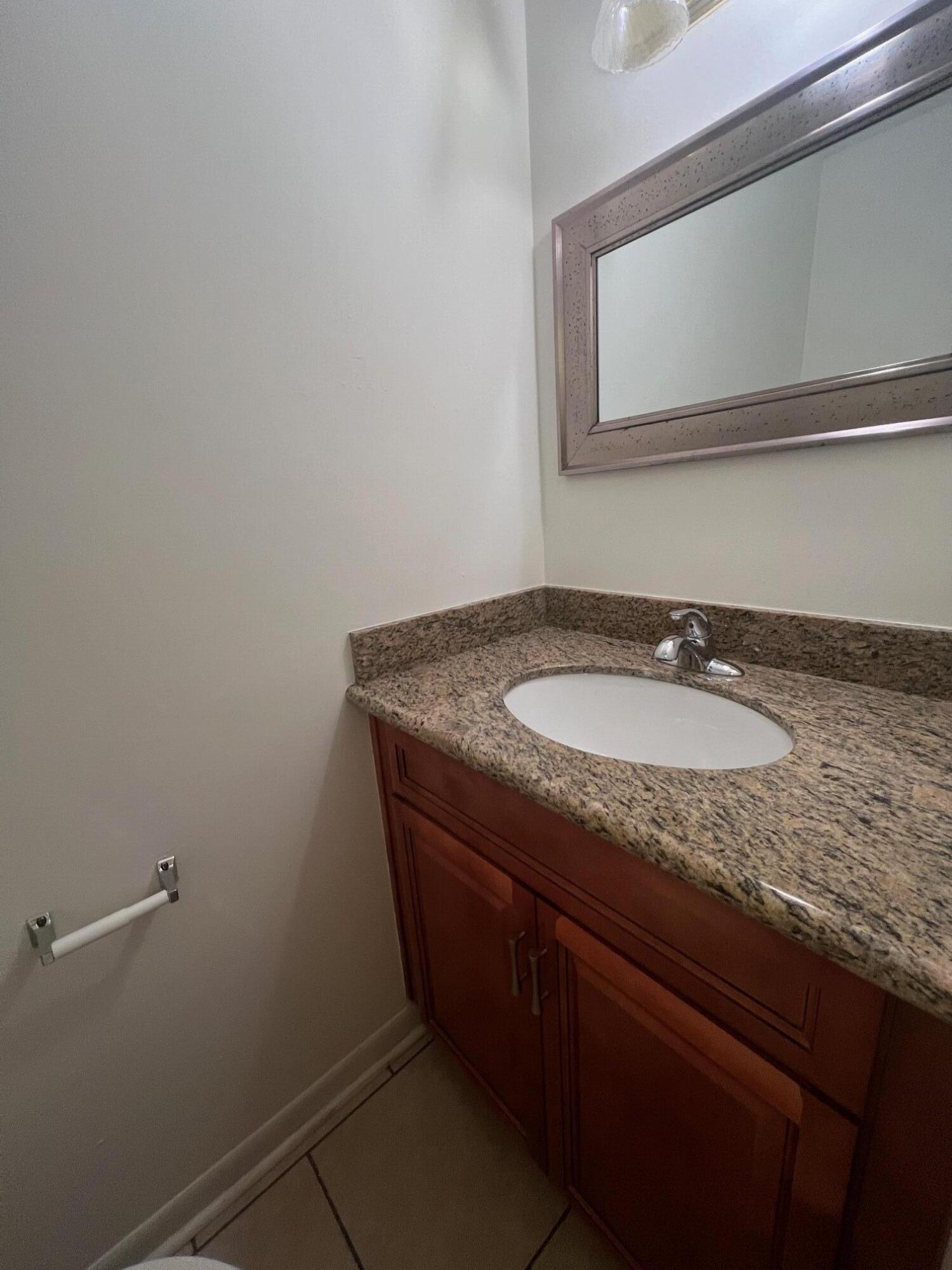 115 Hughes Street Northeast, Unit D4 Fort Walton Beach, FL 32548 - Photo 15 of 29 a bathroom with a granite countertop sink and a mirror