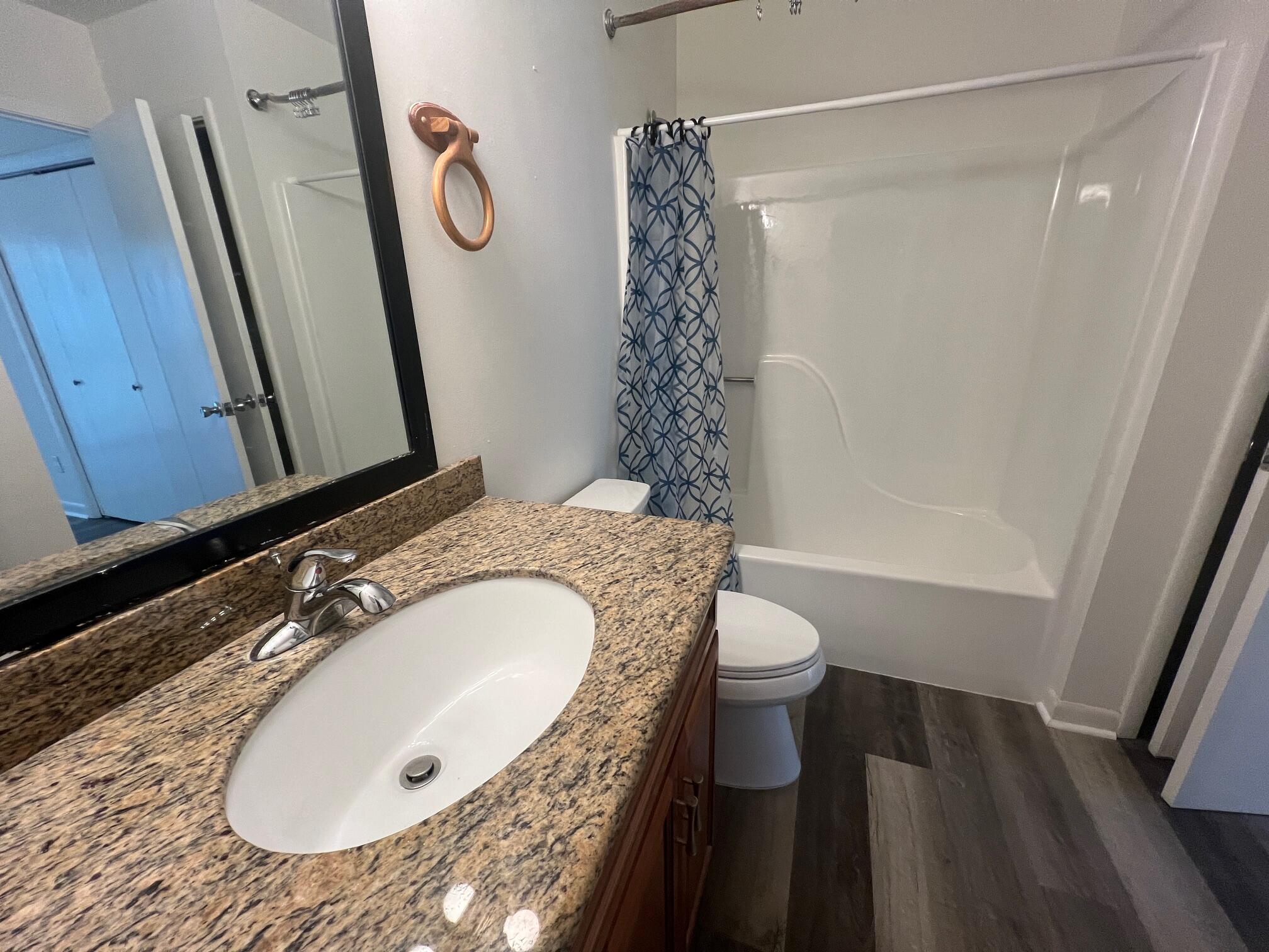 115 Hughes Street Northeast, Unit D4 Fort Walton Beach, FL 32548 - Photo 20 of 29 a bathroom with a granite countertop sink toilet and shower