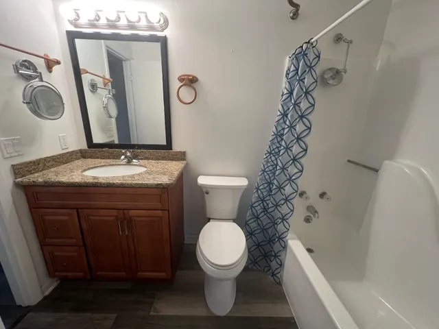 a bathroom with a toilet and shower