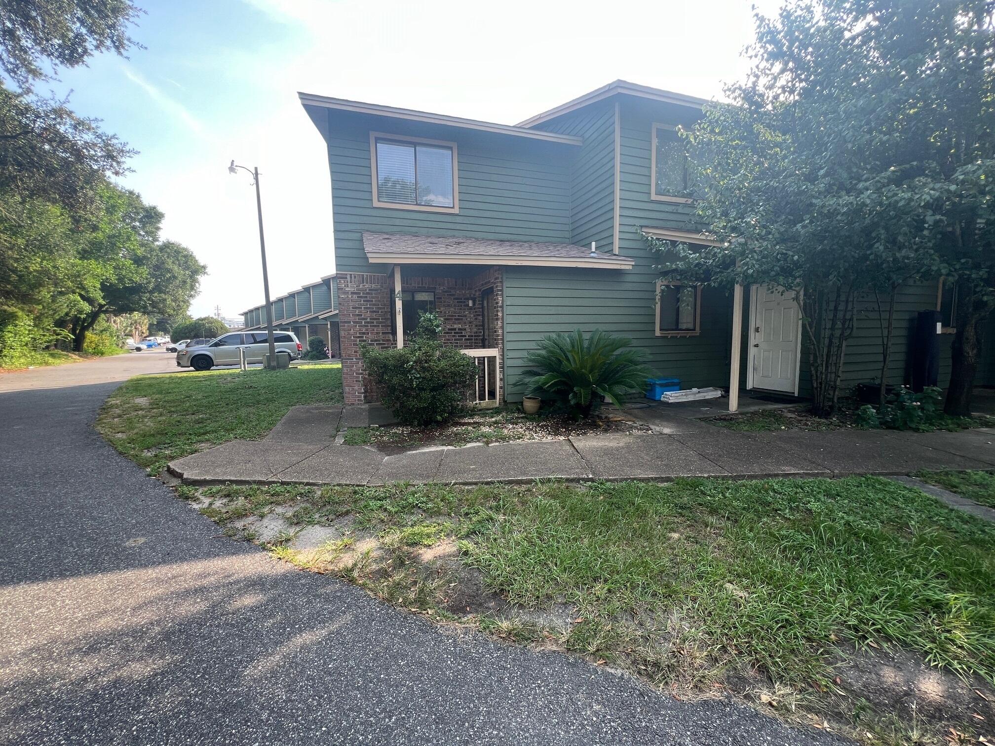 115 Hughes Street Northeast, Unit D4 Fort Walton Beach, FL 32548 - Photo 28 of 29 a view of a yard in front of a house