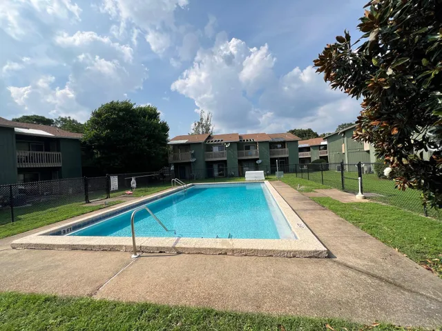a small pool with a bench in front of it