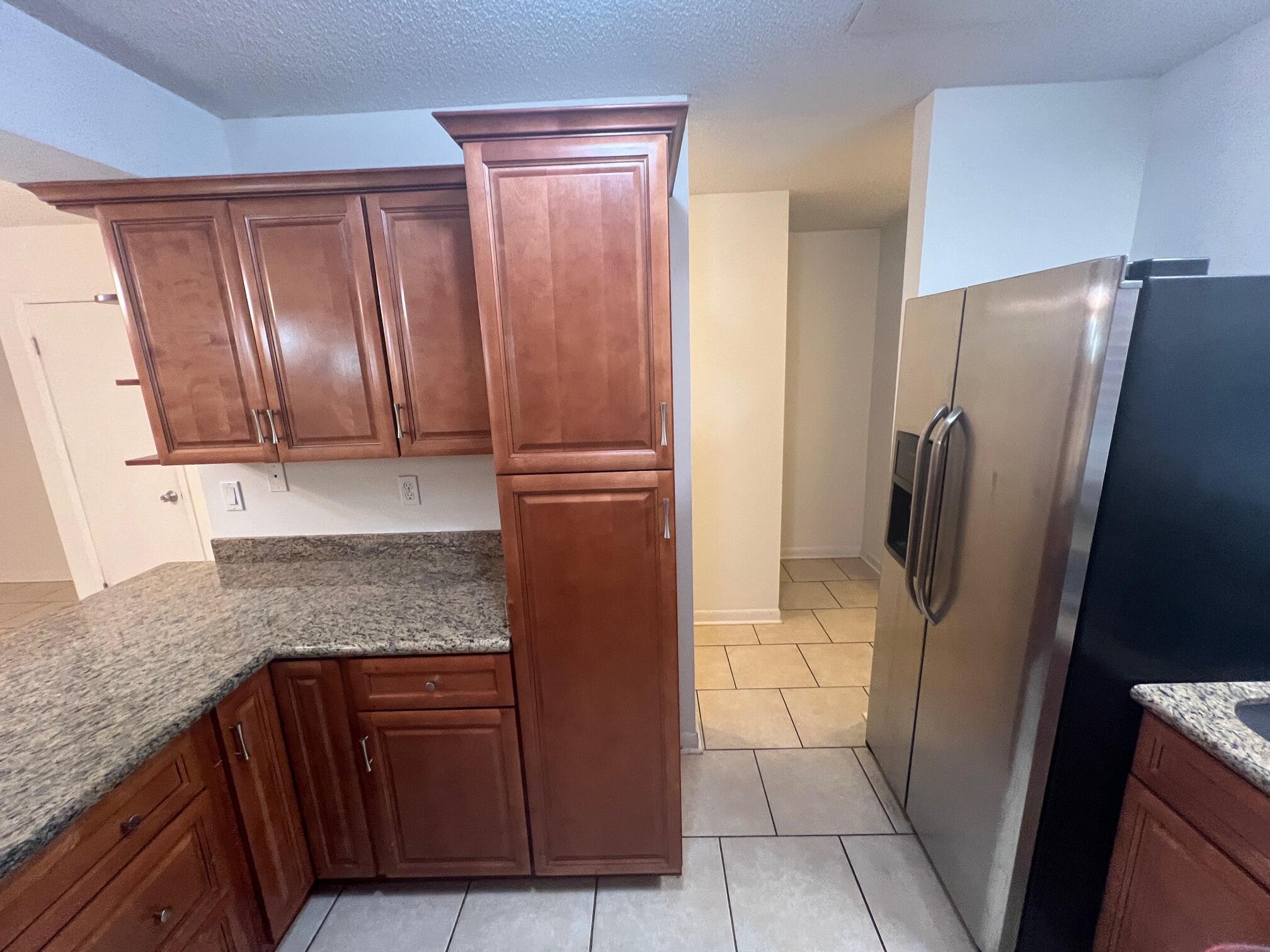 115 Hughes Street Northeast, Unit D4 Fort Walton Beach, FL 32548 - Photo 7 of 29 a kitchen with granite countertop stainless steel appliances and refrigerator