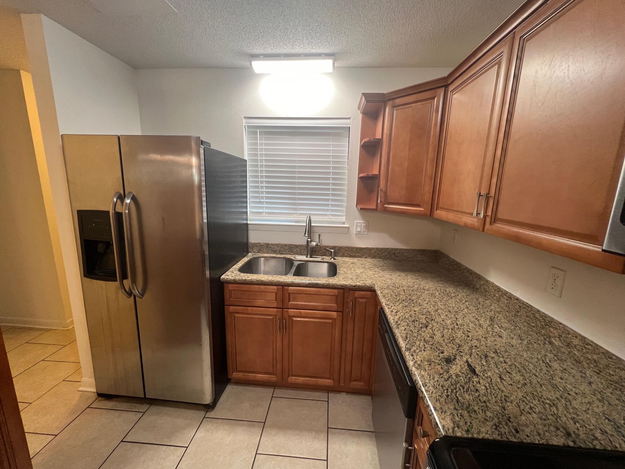 115 Hughes Street Northeast, Unit D4 Fort Walton Beach, FL 32548 - Photo 8 of 29 a kitchen with stainless steel appliances granite countertop a sink stove and refrigerator