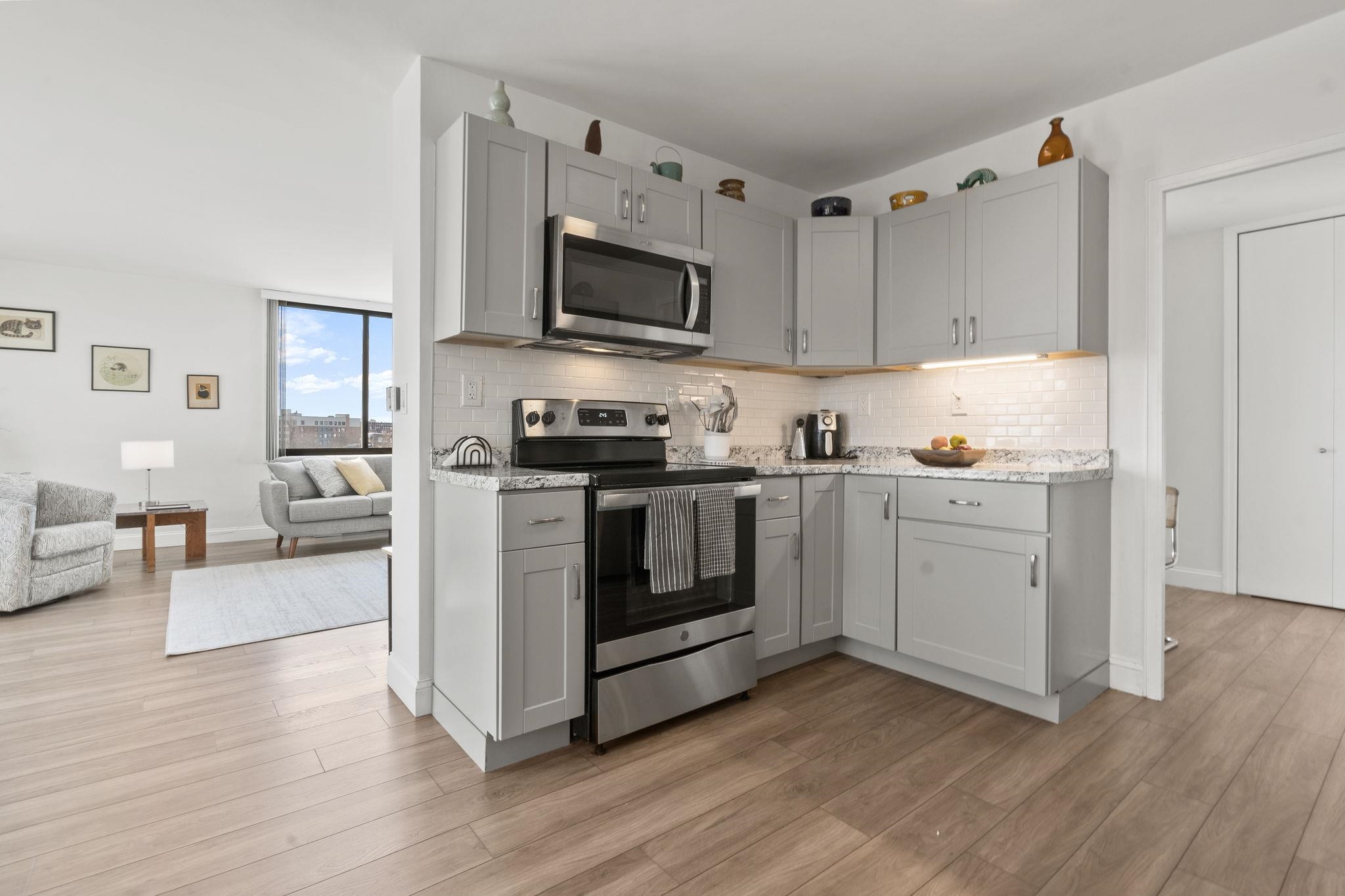 380 Mountain Road, Unit 813 Union City, NJ 07087 - Photo 14 of 40 a kitchen with wooden floors and white stainless steel appliances