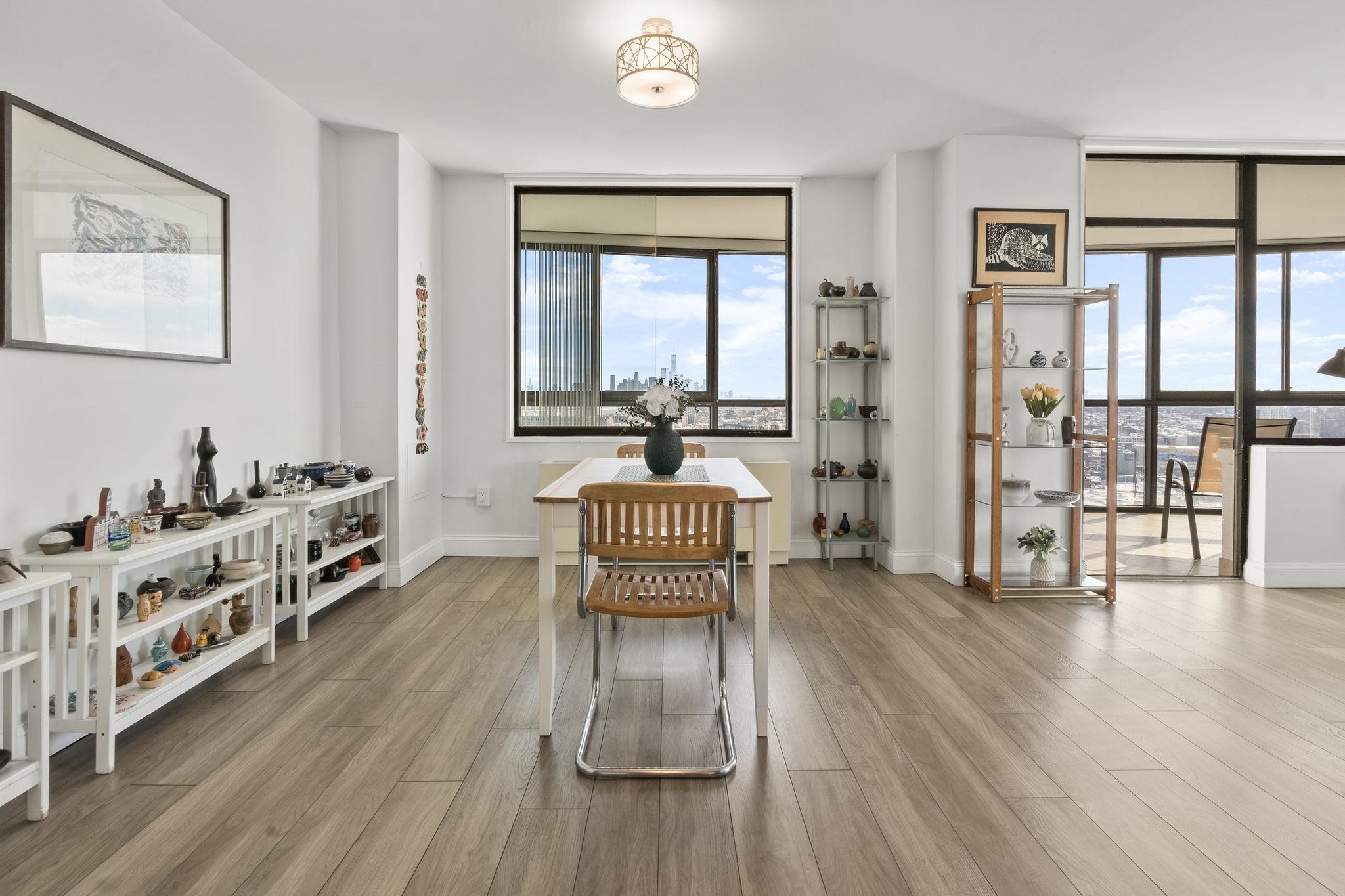 380 Mountain Road, Unit 813 Union City, NJ 07087 - Photo 16 of 40 a work room with furniture wooden floor and windows