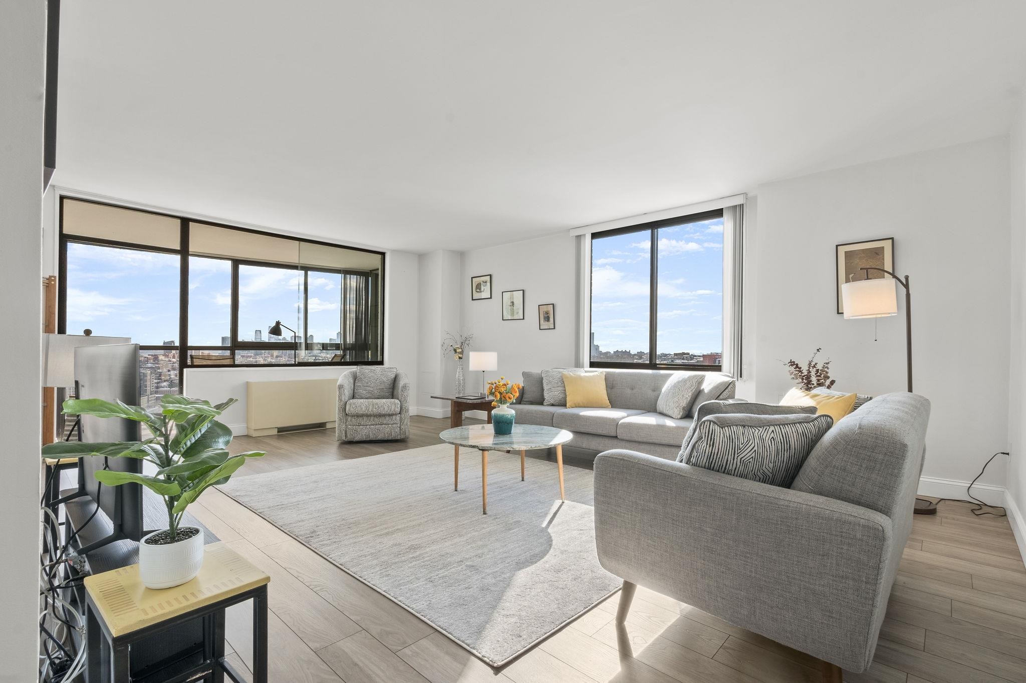 380 Mountain Road, Unit 813 Union City, NJ 07087 - Photo 2 of 40 a living room with furniture and a large window