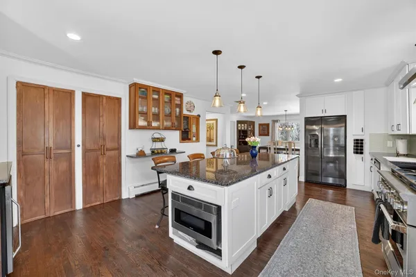 a kitchen with stainless steel appliances a stove a refrigerator and a stove top oven