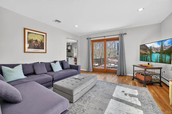 a living room with furniture and a floor to ceiling window