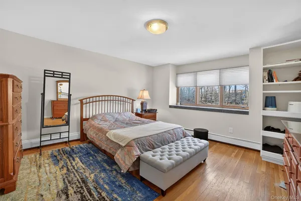 a bedroom with a bed and a table with wooden floor