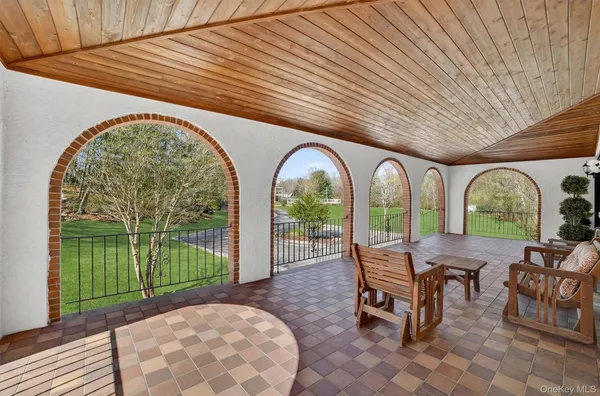 a view of a patio with table and chairs near a yard