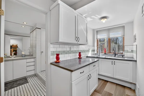 a kitchen with granite countertop a sink and cabinets