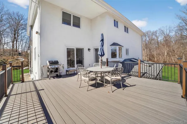 a view of a roof deck with table and chairs floor to ceiling window with wooden floor