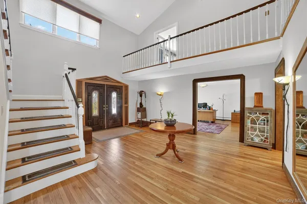 a view of entryway livingroom and hall with wooden floor