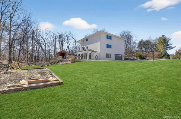 a view of a white house with a yard