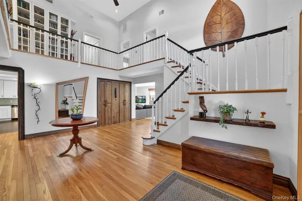 a living room with furniture and wooden floors