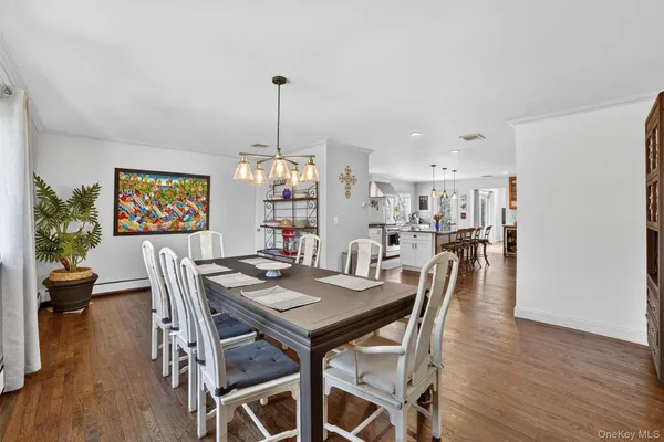 a view of a dining room with furniture wooden floor and chandelier