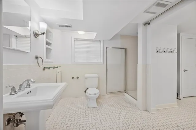 a bathroom with a sink toilet and shower