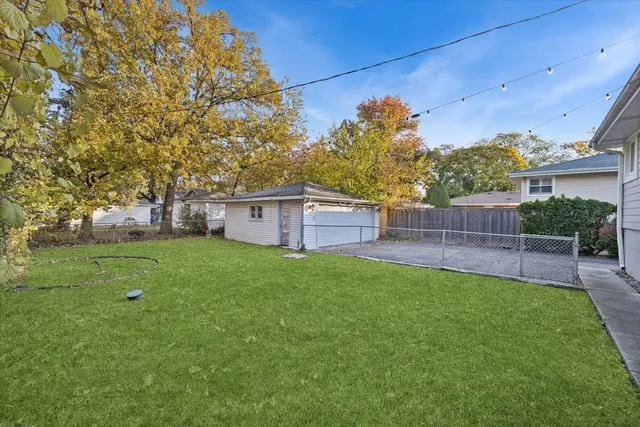 a view of a backyard with a garden and entertaining space