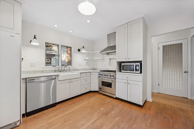 a kitchen with granite countertop white cabinets and white appliances