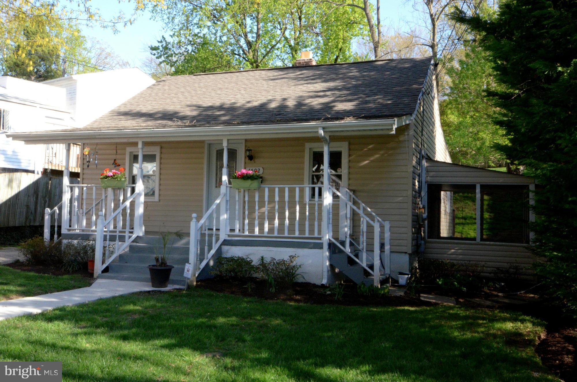 4502 Mahan Road Silver Spring, MD 20906 - Photo 1 of 30 a front view of a house with a yard table and chairs