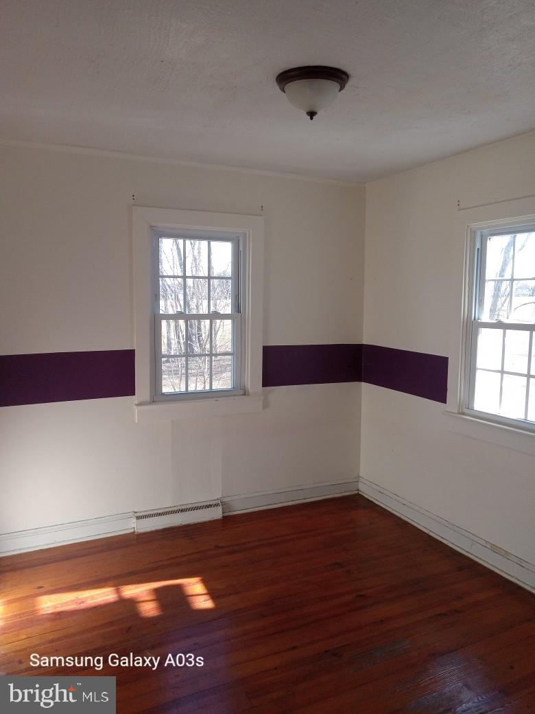 37291 Grass Roots Lane Purcellville, VA 20132 - Photo 16 of 38 a view of empty room with wooden floor and fan