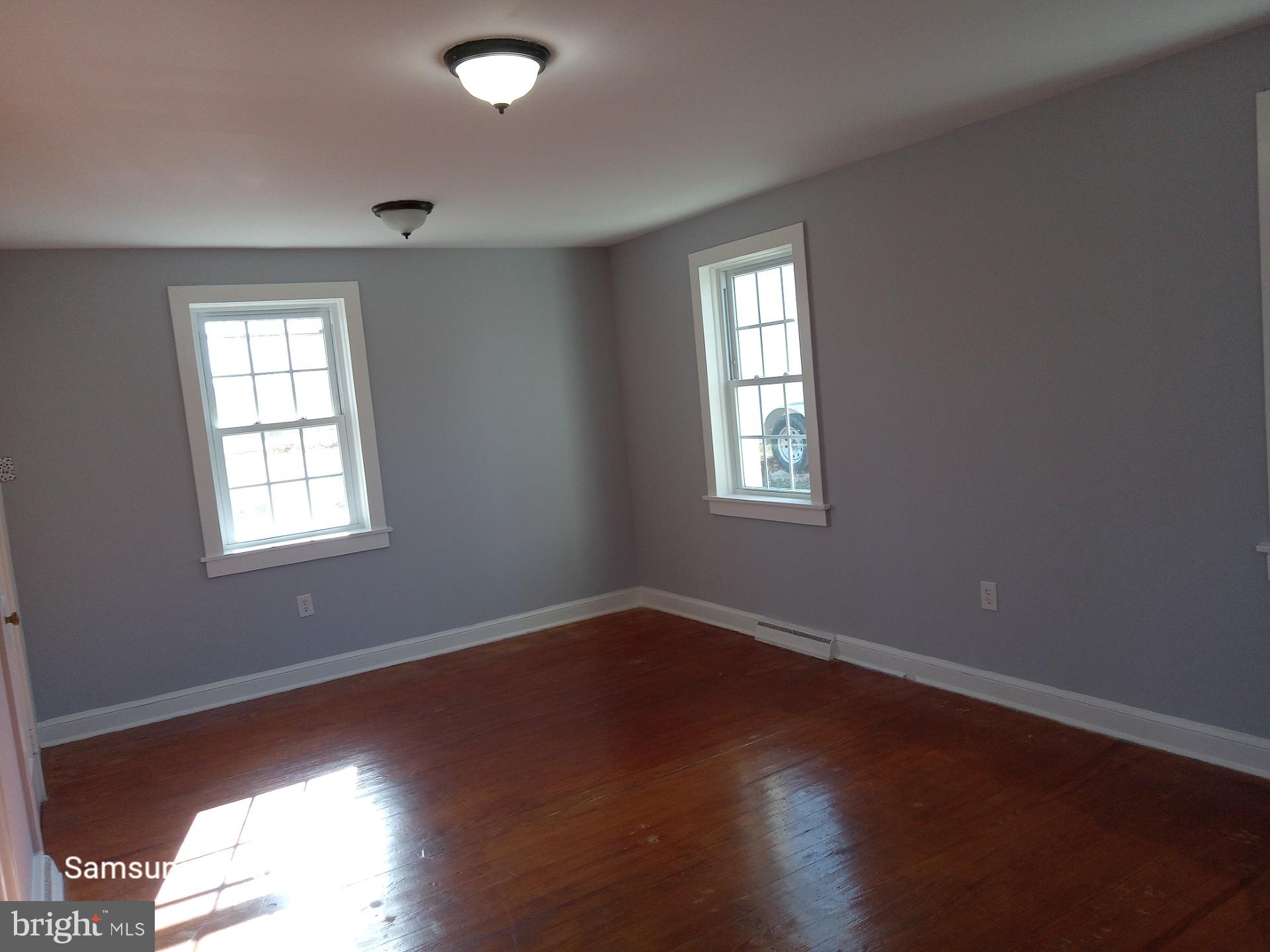 37291 Grass Roots Lane Purcellville, VA 20132 - Photo 35 of 38 a view of an empty room with wooden floor and a window