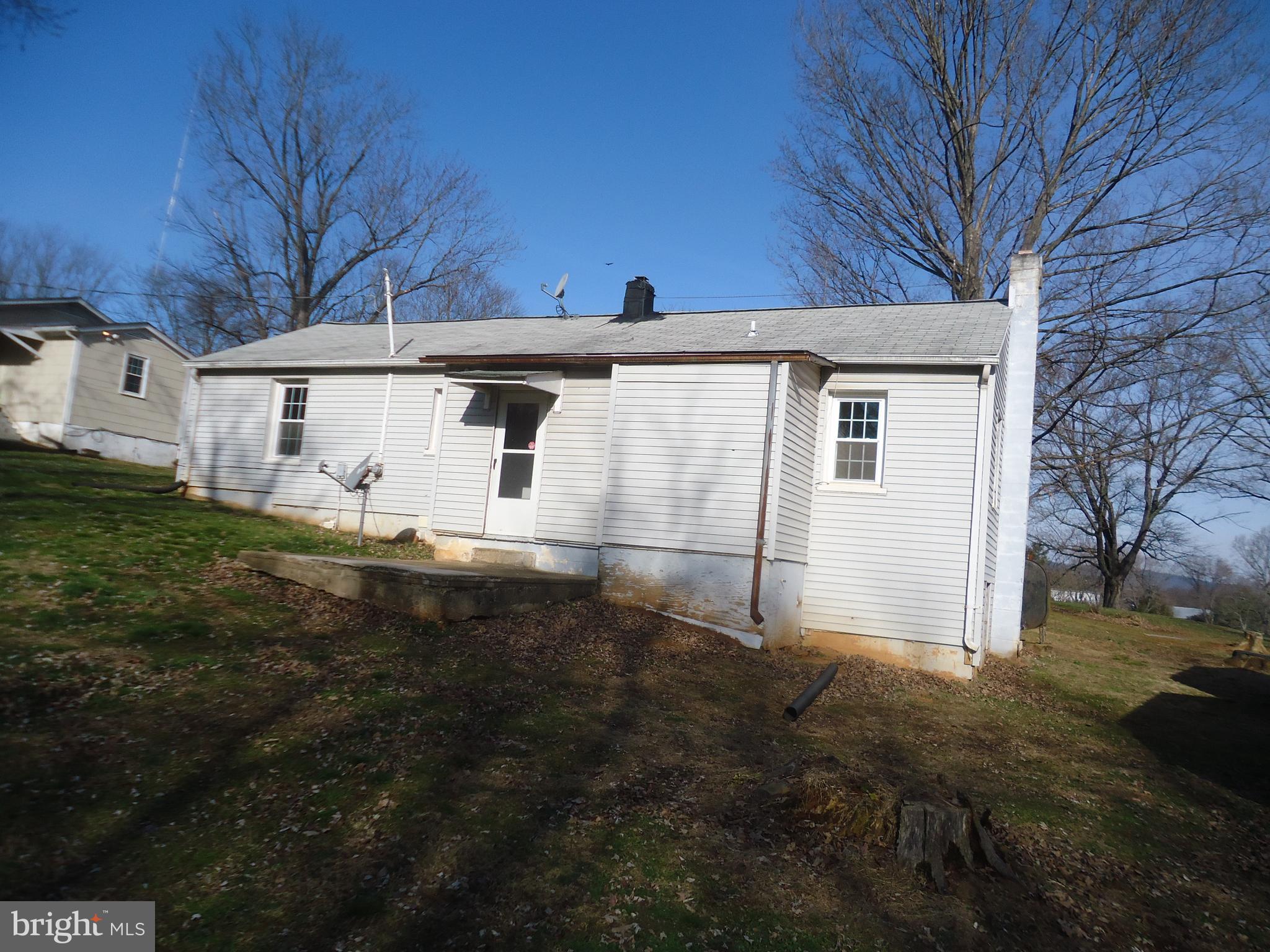 37291 Grass Roots Lane Purcellville, VA 20132 - Photo 4 of 38 a view of a white house that has a big yard with large tree