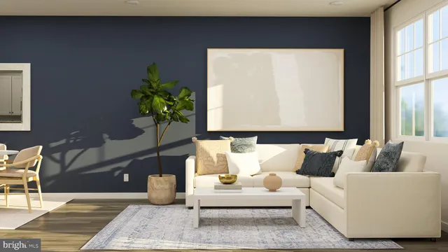a living room with furniture and a potted plant