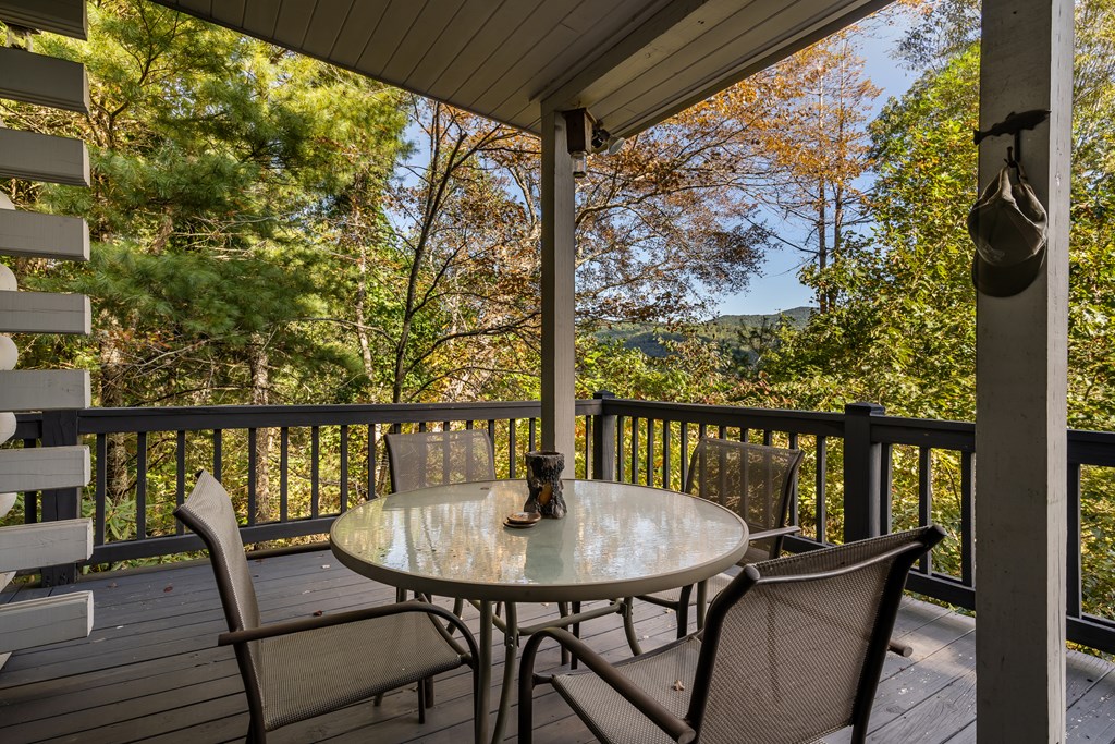 541 Mountain View Circle Blue Ridge, GA 30513 - Photo 36 of 38 a view of a balcony with a table and chairs