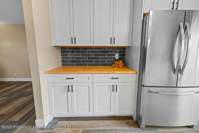a view of a room with wooden floor and windows
