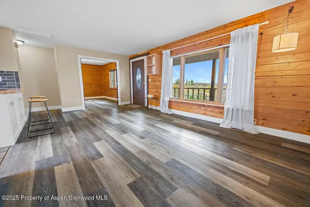 a view of wooden floor and brick walls