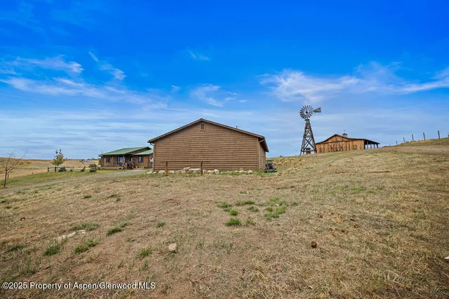 a view of a big yard with an outdoor seating